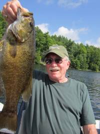 Jim Adler holds up a fish.